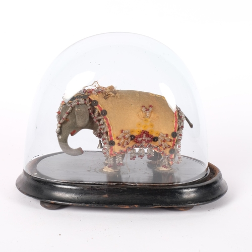 215 - A miniature Indian elephant, with all over jewelled decoration, under a glass dome. H - 16cm.