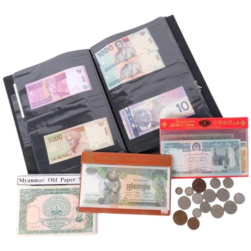 230 - A presentation cased set of 25 Asian bank notes, coins etc including Cambodia, Hungary, Turkey, Indo... 