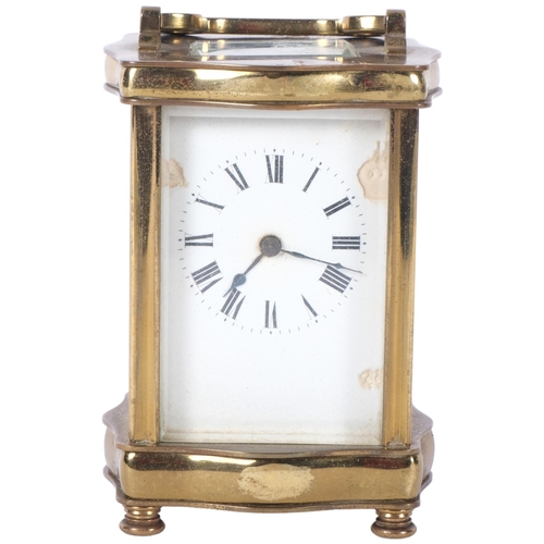 239 - A French brass cased carriage clock with white enamelled dial. H - 12cm. Complete with key.