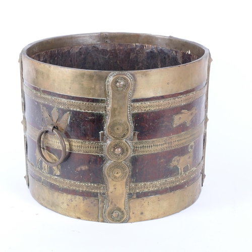 26 - A 19th century Anglo-Indian wood and brass bound bucket, with ring handles, applied strapwork and an... 