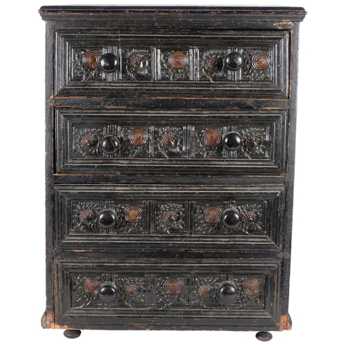 63 - A Victorian ebonised table top chest of 4 drawers, with carved decoration.