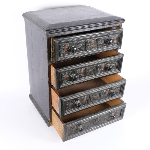 63 - A Victorian ebonised table top chest of 4 drawers, with carved decoration.