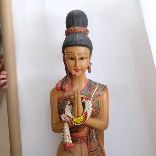 68 - A Thai carved and painted wood figure of a Sawasdee female. H - 152cm.