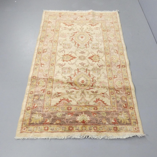 2257 - A cream-ground Keshan rug. 177x107cm.