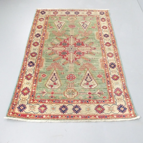 2258 - A green-ground Caucasian rug. 177x119cm.