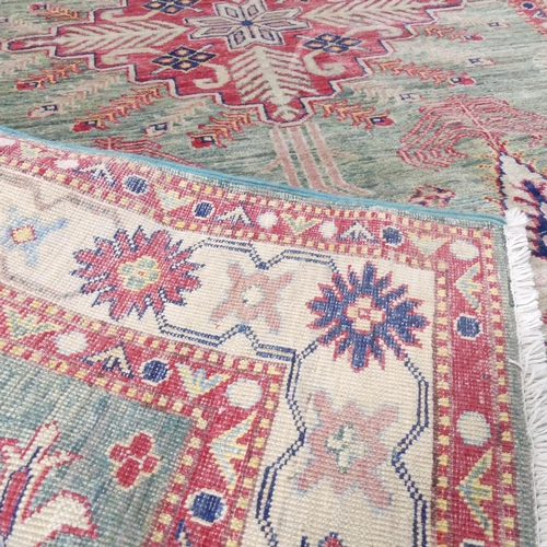 2258 - A green-ground Caucasian rug. 177x119cm.