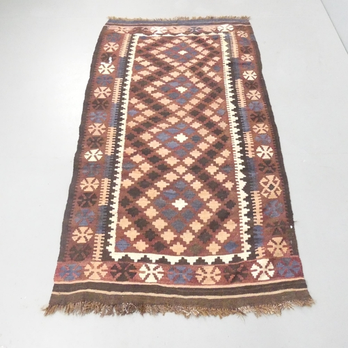 2260 - A brown-ground Kazak rug. 186x100cm.