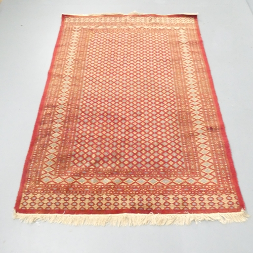 2264 - A red-ground Sumak rug. 180x125cm.