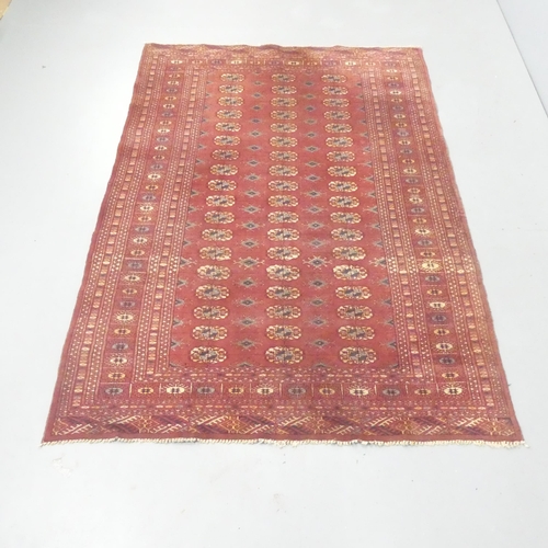 2265 - A red-ground Tekke rug. 180x127cm