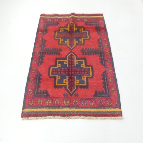 2275 - A red-ground Baluchi rug. 140x79cm.