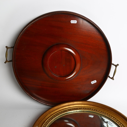 744 - A circular gilt-framed wall mirror, diameter 40cm, and an Edwardian mahogany circular 2-handled tea ... 