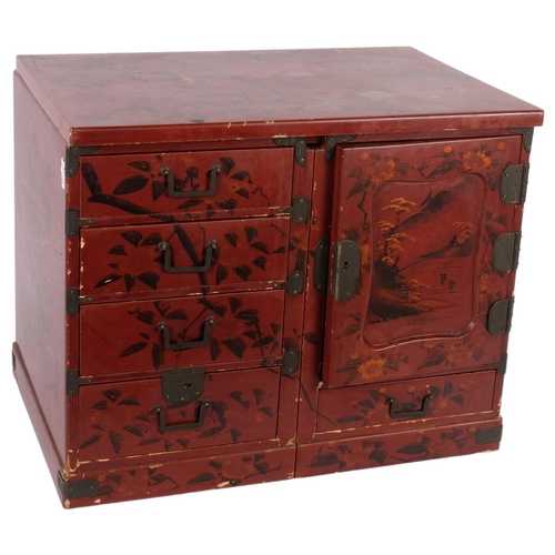 397 - A Japanese red lacquered table top jewellery/travelling chest, converting to miniature desk, with fi... 