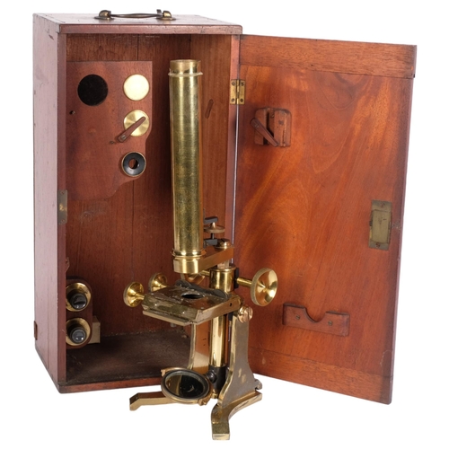 465 - A brass student's microscope with accessories, in fitted mahogany case, H39cm