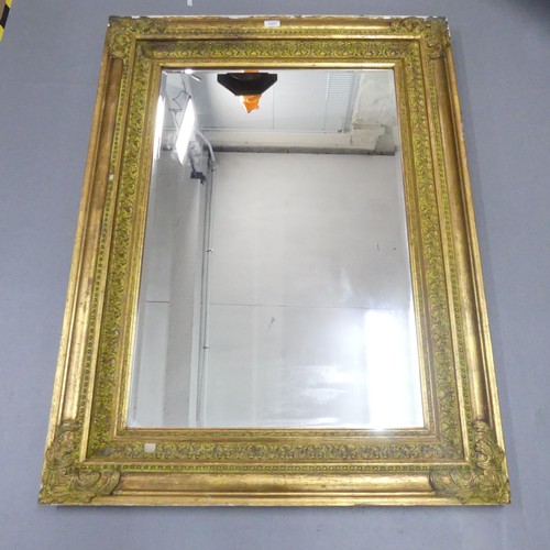 2251 - A gilt-painted continental style bevel edged wall mirror. 87x118cm.