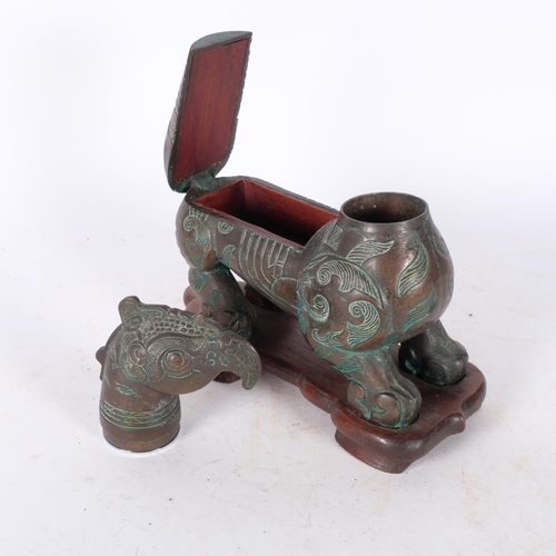 413 - An Oriental verdigris bronze mythical beast, on fitted wooden stand, H23cm