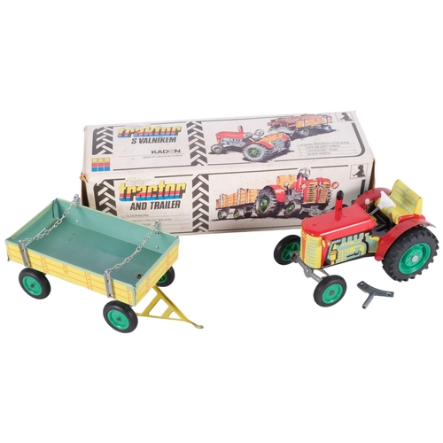 439 - A Zetor wind-up clockwork tin tractor and trailer, made by Kaden in Czechoslovakia, in original box