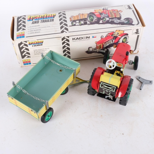 439 - A Zetor wind-up clockwork tin tractor and trailer, made by Kaden in Czechoslovakia, in original box