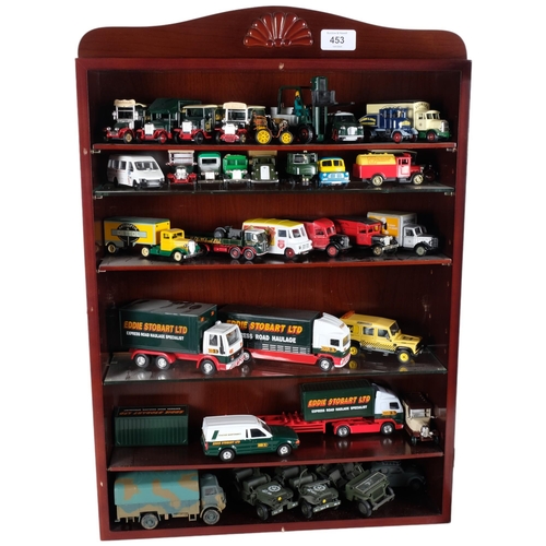 453 - A quantity of diecast vehicles, many Eddie Stobart related in nature, in associated glass-front wall... 