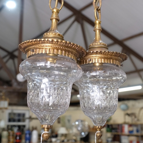 461 - A pair of small cut-crystal pendant lights, with gilt-metal mounts, 14cm across