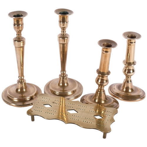 469 - 2 pairs of Georgian brass candlesticks, tallest 24cm, and a brass cribbage board