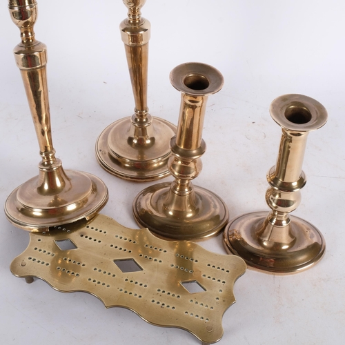 469 - 2 pairs of Georgian brass candlesticks, tallest 24cm, and a brass cribbage board