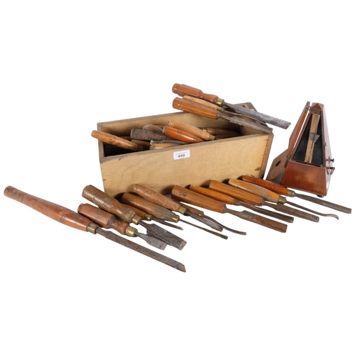 480 - A box of carpentry chisels with turned wood handles, a metronome etc