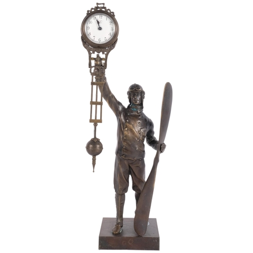 489 - A reproduction mystery clock, supported by a pilot figure with propeller, H37.5cm