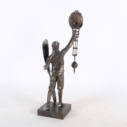 489 - A reproduction mystery clock, supported by a pilot figure with propeller, H37.5cm