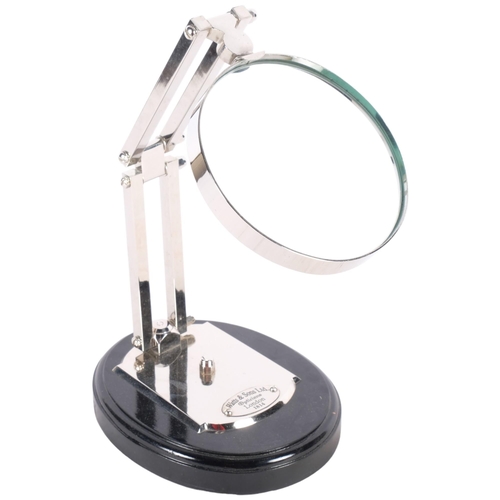 491 - A large reproduction magnifying glass mounted on stand, H28cm