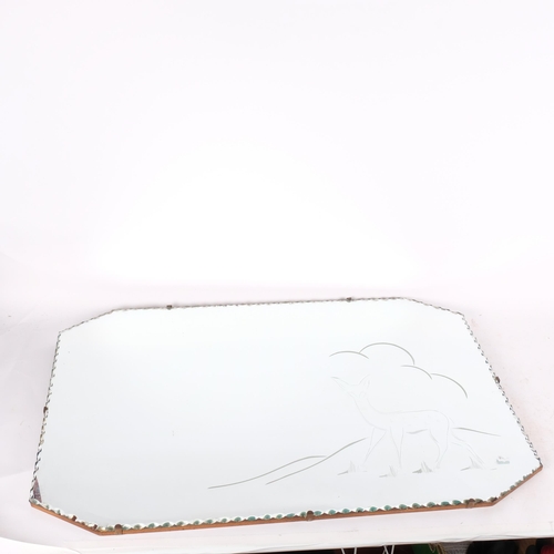 501 - A 1950s canted corner wall mirror, with scalloped edge and deer decoration, 76cm x 50cm overall