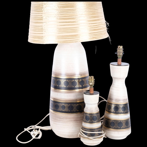 271 - A graduated set of 3, circa 1970s, West German pottery table lamps, with gilded banded decoration, t... 