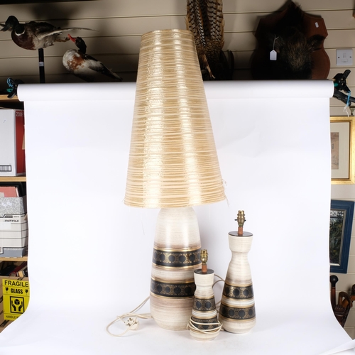 271 - A graduated set of 3, circa 1970s, West German pottery table lamps, with gilded banded decoration, t... 