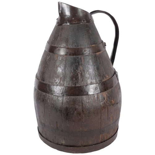 272 - A Continental coopered oak jug with metal bands and handle, H44cm