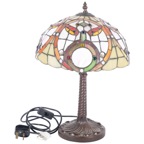 278 - A Tiffany style table lamp on cast-metal base, with multi-coloured shade, H42cm