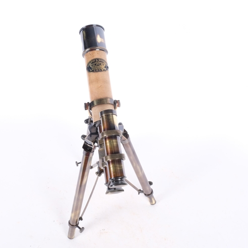 286 - A leather-bound brass telescope on adjustable tripod stand, telescope length 25.5cm