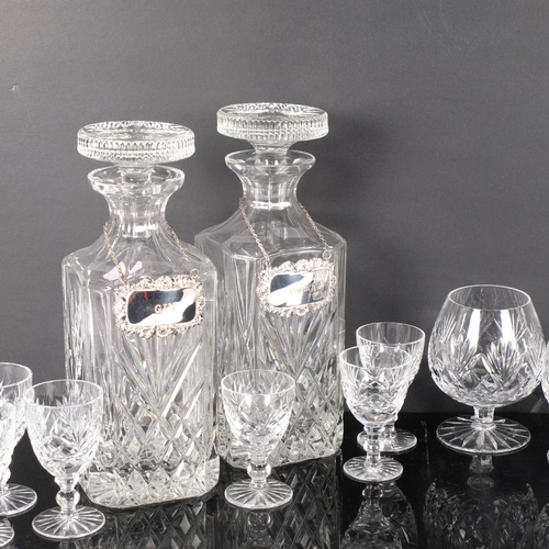 303 - A pair of cut-crystal decanters and stoppers, with plated labels, 24cm, Brandy and liqueur glasses, ... 