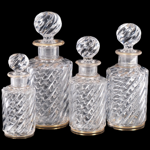 317 - A graduated set of swirled glass decanters and stoppers, with gilded decoration, tallest 17.5cm, A/F