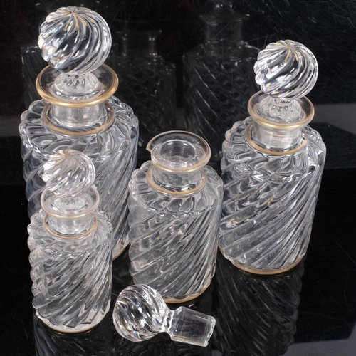 317 - A graduated set of swirled glass decanters and stoppers, with gilded decoration, tallest 17.5cm, A/F