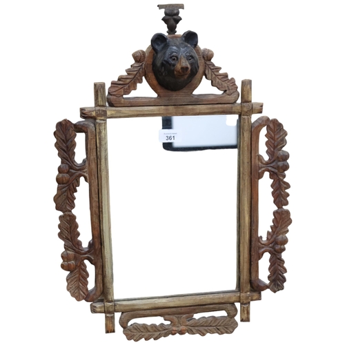 361 - Black Forest carved oak framed wall mirror, with bear's head pediment, H53cm