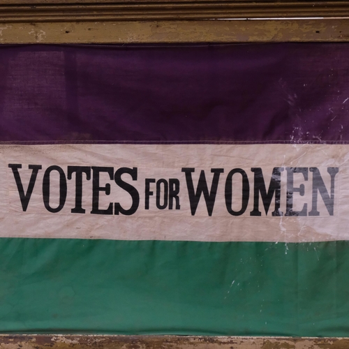 376 - A framed reproduction Suffragette Votes For Women flag in machined cotton, 89cm x 119cm overall