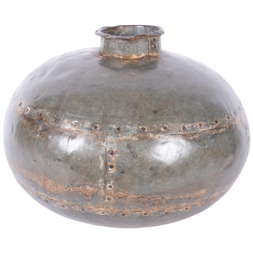 382 - A studded metal industrial vase. 35cm diameter