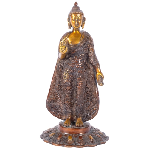 383 - An Oriental embossed and gilded bronze standing Buddha figure, H27cm