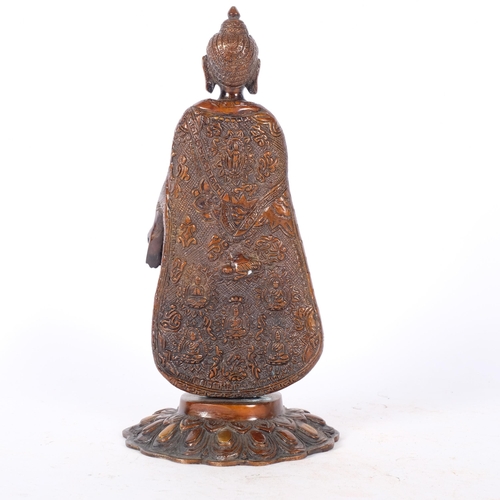 383 - An Oriental embossed and gilded bronze standing Buddha figure, H27cm