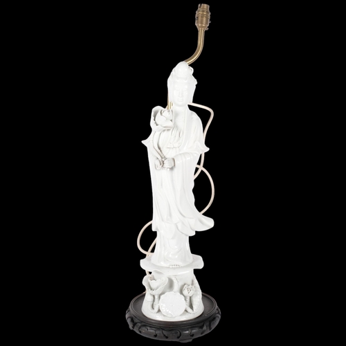 384 - A blanc de chine porcelain figure lamp, on carved and pierced wood plinth, H68cm overall (1 finger A... 