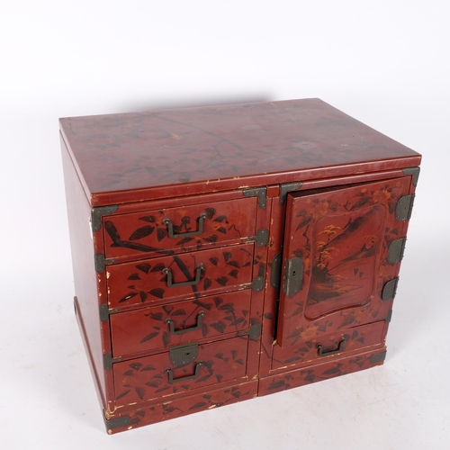 397 - A Japanese red lacquered table top jewellery/travelling chest, converting to miniature desk, with fi... 