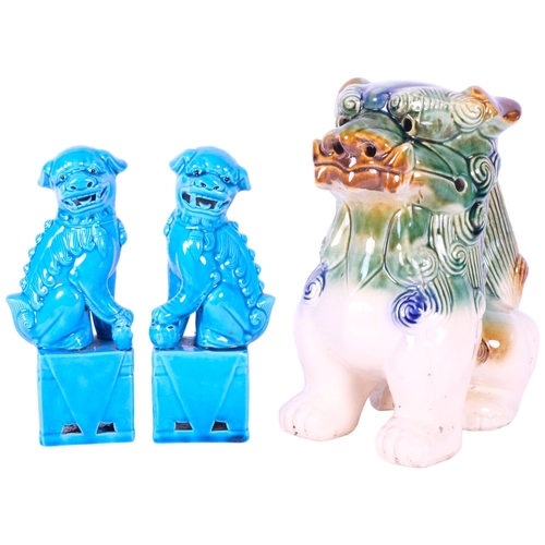 400 - Polychrome glazed dog of fo, H24cm, and a pair of blue glazed dogs of fo on plinths