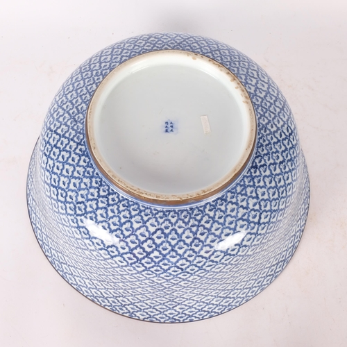 406 - A large Chinese blue and white bowl, with allover decoration and 6 character mark, 38cm across