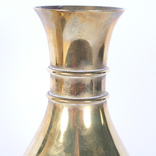 407 - A pair of heavy brass vases on feet, 25.5cm