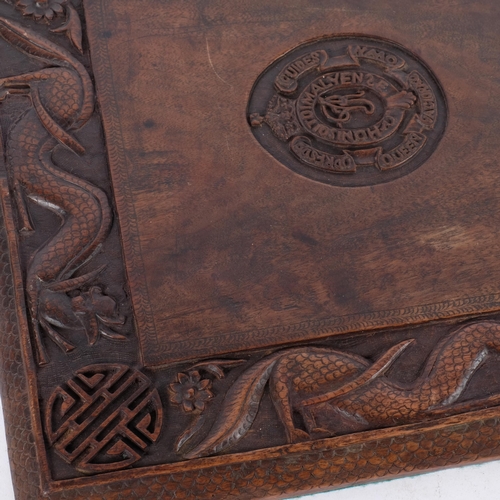 541 - A 20th century carved wooden panel, with coats of arms for the 