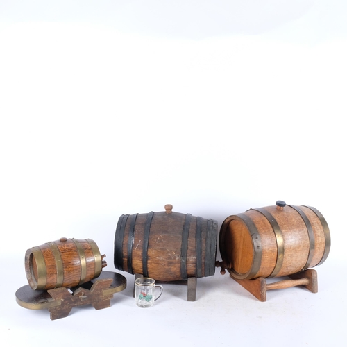 544 - A group of 3 Whisky or wine barrels, brass and iron-bound, on associated display stands, all with ta... 